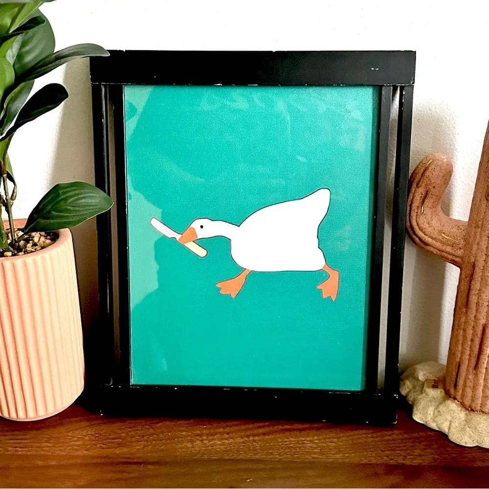 Silly Goose with a Butter Knife Green Canvas Print Black Framed Quirky Wall Art